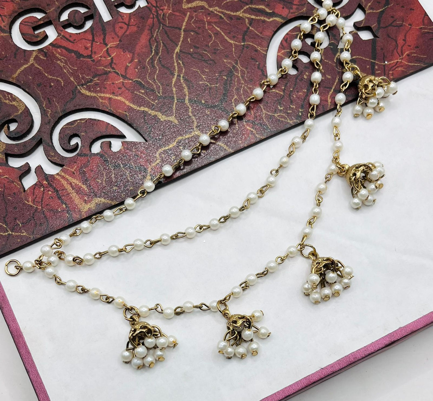 white balls with golden chain sahary
